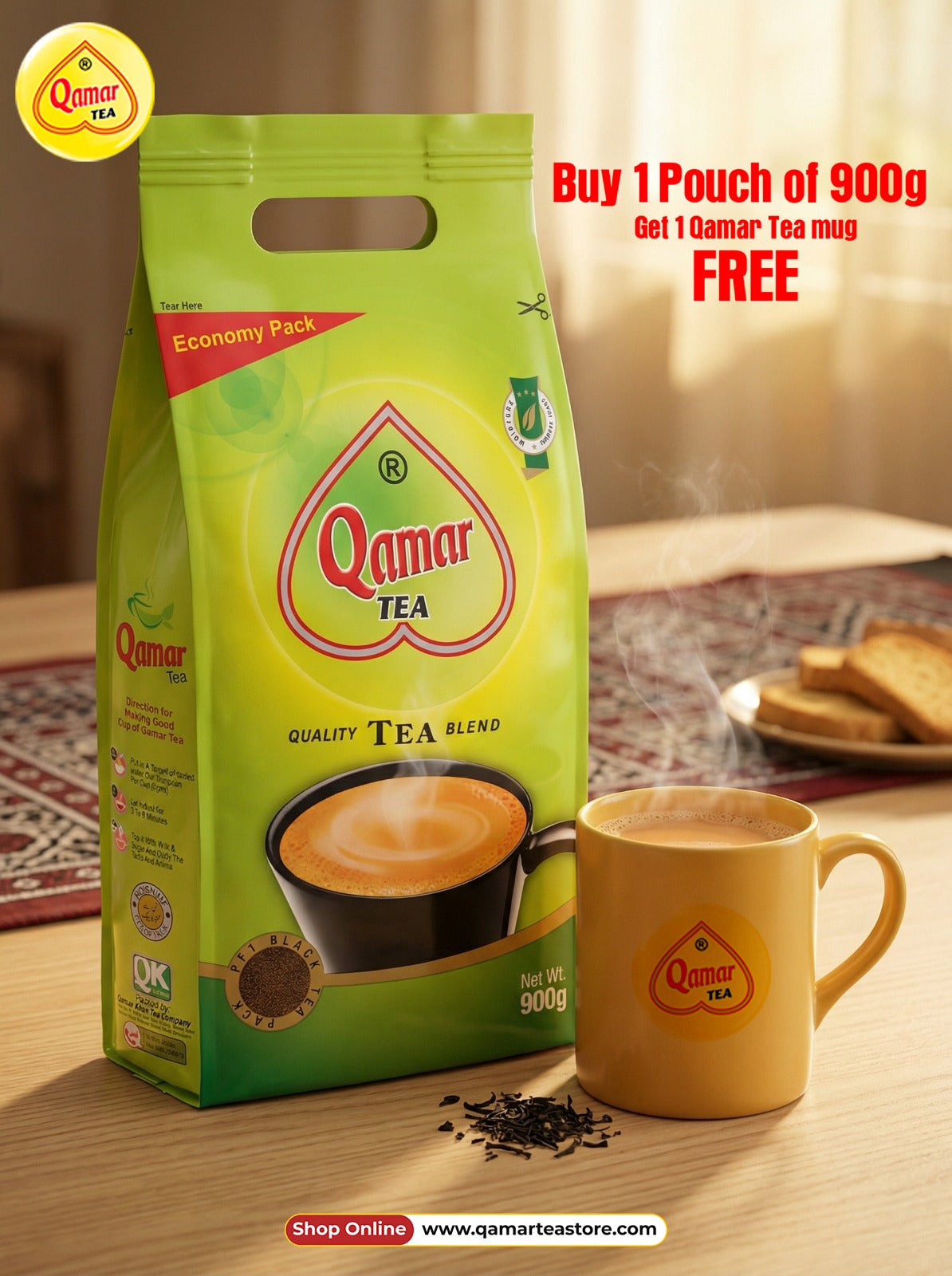 Qamar Tea package with a free tea mug offer on a wooden table.