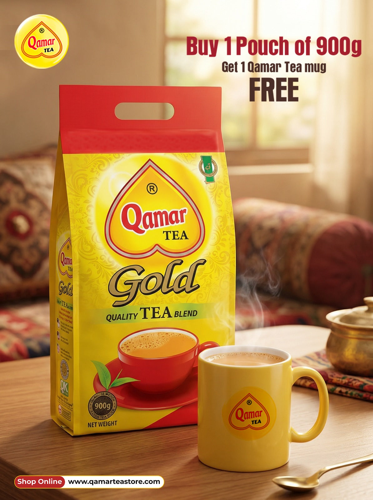 Qamar Tea Gold packaging with a yellow mug on a wooden table.